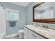 Well-lit bathroom with a vanity with stone countertops and a large mirror at 1416 Glencoe Dr, Mount Pleasant, SC 29464