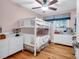 Charming bedroom featuring a bunk bed, light pink walls, white dresser and hardwood floors at 1416 Glencoe Dr, Mount Pleasant, SC 29464
