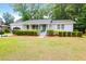 Charming one-story home featuring a well-manicured lawn and beautiful front yard landscaping at 1416 Glencoe Dr, Mount Pleasant, SC 29464