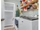 Convenient laundry room with washer, dryer, and shelving for storage at 1416 Glencoe Dr, Mount Pleasant, SC 29464