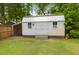 Backyard showing a white shed with black hardware and manicured lawn at 1416 Glencoe Dr, Mount Pleasant, SC 29464