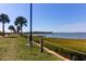 Scenic walking path with views of water and lush greenery and a rope fence with Palm trees on a sunny day at 1416 Glencoe Dr, Mount Pleasant, SC 29464
