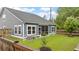 The backyard features a screened-in porch, lush green lawn, and mature trees, offering a private and serene outdoor space at 148 Haverhill St, Summerville, SC 29486