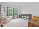 A clean spare bedroom with a chair, lots of natural light, and a storage shelf at 148 Haverhill St, Summerville, SC 29486