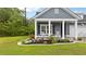Charming front yard featuring a well-manicured lawn and a cozy front porch with rocking chairs at 148 Haverhill St, Summerville, SC 29486