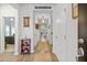 Bright hallway showcasing hardwood floors, white walls, and inviting decor leading to other rooms at 148 Haverhill St, Summerville, SC 29486