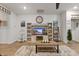 Bright living room features a stylish entertainment center and wood-look floors at 148 Haverhill St, Summerville, SC 29486