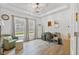 Sunlit home office with wood floors, tray ceiling, comfortable chair, and two large windows at 148 Haverhill St, Summerville, SC 29486