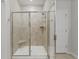 Modern glass shower with beige tile, rainfall shower head, and built-in corner seat at 148 Haverhill St, Summerville, SC 29486