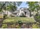 Lush backyard with a well-maintained lawn, mature trees, and a charming picket fence at 1517 Faith St, Mount Pleasant, SC 29466