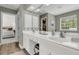 Bright bathroom with double vanity sinks, a large mirror, and a walk-in closet at 1517 Faith St, Mount Pleasant, SC 29466