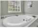 Relaxing soaking tub with jets and a view of the window at 1517 Faith St, Mount Pleasant, SC 29466