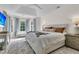 Bright bedroom with large windows, a cozy sitting bench, and an elegant accent rug at 1517 Faith St, Mount Pleasant, SC 29466