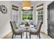 Sun-drenched breakfast nook featuring a built-in bench, plush cushions, and stylish decor with backyard view at 1517 Faith St, Mount Pleasant, SC 29466
