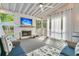 Relaxing covered porch featuring a fireplace, TV, comfortable seating, and natural light at 1517 Faith St, Mount Pleasant, SC 29466