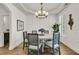 Elegant dining room with a round table, modern chandelier, and sophisticated wall paneling at 1517 Faith St, Mount Pleasant, SC 29466