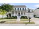 Inviting two-story home featuring a charming front porch, black shutters, and well-maintained landscaping at 1517 Faith St, Mount Pleasant, SC 29466