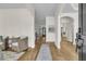 Bright foyer with wood floors, elegant archways, and a view into the living room at 1517 Faith St, Mount Pleasant, SC 29466