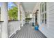 Spacious front porch with rocking chairs, stylish columns, and a view of the surrounding neighborhood at 1517 Faith St, Mount Pleasant, SC 29466