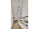 Bright stairwell with hardwood steps, white railing, and a stylish black pendant light at 1517 Faith St, Mount Pleasant, SC 29466