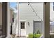 View of the back door of a home with brick pavers and outdoor lighting at 1527 Wando View St, Charleston, SC 29492