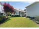 Expansive backyard featuring lush lawn, screened porch, and mature trees at 1527 Wando View St, Charleston, SC 29492