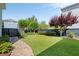 Well-maintained backyard with lush lawn, mature trees, and a dark wooden fence at 1527 Wando View St, Charleston, SC 29492