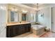 Bright bathroom with double sink vanity, soaking tub, and decorative lighting at 1527 Wando View St, Charleston, SC 29492