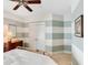 Bedroom with a brass bed frame, striped walls, neutral carpet and white closet doors at 1527 Wando View St, Charleston, SC 29492