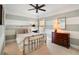 Bedroom with a brass bed frame, striped walls, and neutral carpet at 1527 Wando View St, Charleston, SC 29492