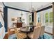 Elegant dining room featuring stylish chandelier, blue accent wall, and a dining table at 1527 Wando View St, Charleston, SC 29492