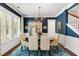 Elegant dining room featuring stylish chandelier, blue walls, and a display cabinet at 1527 Wando View St, Charleston, SC 29492