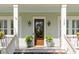 Welcoming front porch with a craftsman-style door, stylish light fixtures, and potted plants at 1527 Wando View St, Charleston, SC 29492