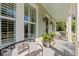 Relaxing front porch featuring comfortable seating, stylish decor, and ample natural light at 1527 Wando View St, Charleston, SC 29492