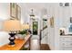 Inviting hallway featuring hardwood floors, stylish light fixtures, and a view of the front door with a wreath at 1527 Wando View St, Charleston, SC 29492