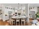Beautiful kitchen with a large island, white cabinetry, stainless steel appliances and pendant lighting at 1527 Wando View St, Charleston, SC 29492