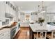 Spacious kitchen with white cabinets, a large island with seating, and stainless steel appliances at 1527 Wando View St, Charleston, SC 29492