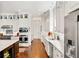 Bright kitchen with stainless steel appliances, white cabinetry, marble countertops, and hardwood floors at 1527 Wando View St, Charleston, SC 29492