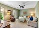 Cozy living room with plush seating, ceiling fan, and serene green textured walls at 1527 Wando View St, Charleston, SC 29492