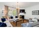 Bright living room with fireplace, plantation shutters, and modern light fixture at 1527 Wando View St, Charleston, SC 29492