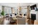 Elegant living room featuring comfortable seating, hardwood floors, a fireplace, and natural light at 1527 Wando View St, Charleston, SC 29492