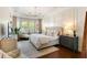 Comfortable main bedroom featuring a decorative tray ceiling, lots of natural light, and a sitting area at 1527 Wando View St, Charleston, SC 29492