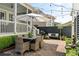 Charming outdoor patio area with dining table, white umbrella, and string lights at 1527 Wando View St, Charleston, SC 29492