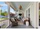 Screened porch with outdoor seating, fan and views of the landscaped yard at 1527 Wando View St, Charleston, SC 29492