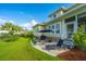 Private backyard features stone patio, lounge chair, grill, and manicured lawn at 1545 Calaveras Cir, Mount Pleasant, SC 29466