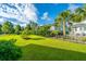 Expansive backyard featuring lush green lawn, trees, and manicured landscaping at 1545 Calaveras Cir, Mount Pleasant, SC 29466