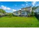 Spacious backyard with a patio, lush lawn, mature trees, and black fence at 1545 Calaveras Cir, Mount Pleasant, SC 29466