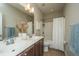 Bright bathroom featuring double sinks, framed mirror, shower and tub combination at 1545 Calaveras Cir, Mount Pleasant, SC 29466