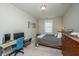 Bright bedroom with a gray bed, wooden dresser, and a computer desk for work or study at 1545 Calaveras Cir, Mount Pleasant, SC 29466