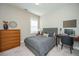 Neutral bedroom featuring a gray bed, wood dresser, a computer desk, and plenty of natural light at 1545 Calaveras Cir, Mount Pleasant, SC 29466